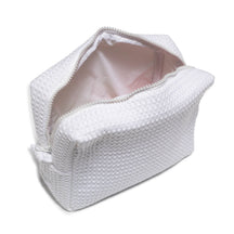 A white zippered waffle pouch with a textured exterior and an open top, revealing a spacious, dark-lined interior.