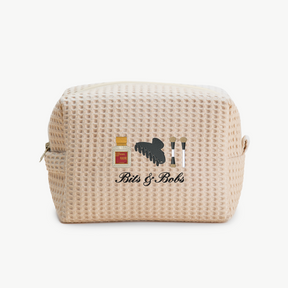 Beige waffle-textured cosmetic bag with 'Bits & Bobs' branding on a white background