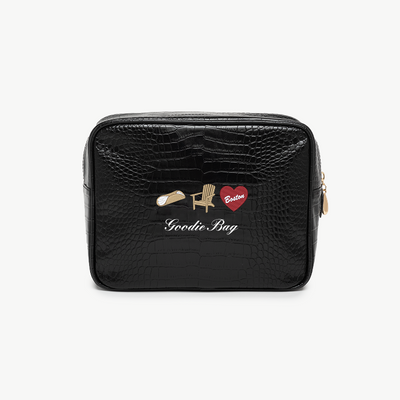 Black好色小方包 with decorative pins on a white background