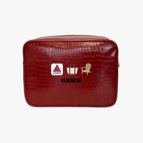Red toiletry bag with icons and 'GRWM' text on a white background
