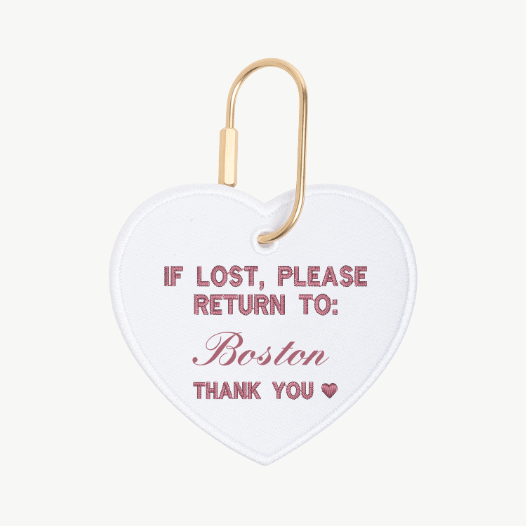 Heart-shaped tag with 'If lost, please return to Boston' text on a white background