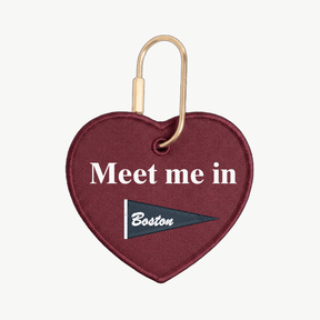 Heart-shaped keychain with 'Meet me in Boston' text on a white background
