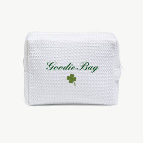 White textured goodie bag with 'Goodie Bag' text and a green clover leaf on a white background