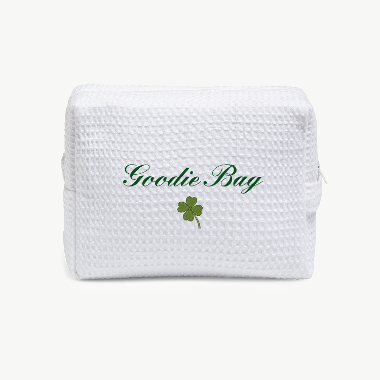 White textured goodie bag with 'Goodie Bag' text and a green clover leaf on a white background