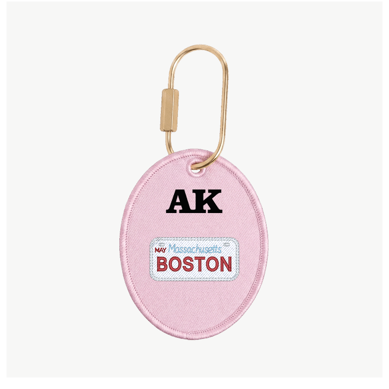 Pink keychain with 'AK' and 'Boston' text on a white background