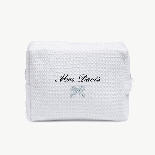 A white waffle pouch with the text 'Mrs. Davis' and a small embroidered blue ribbon below on the front, displayed on a plain white background.