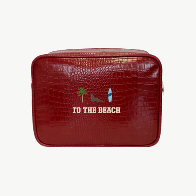 Red textured bag with 'To the Beach' text and icons on a white background