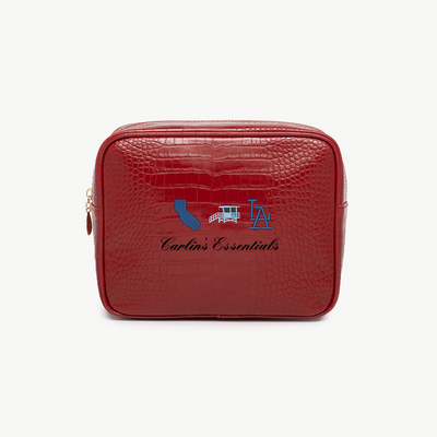 Red toiletry bag with 'Carlin's Essentials' branding on a white background