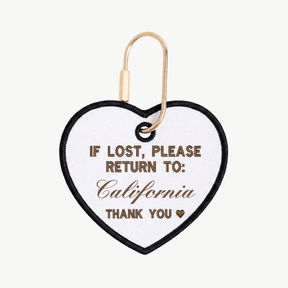 Heart-shaped tag with text 'If lost, please return to: California' on a white background