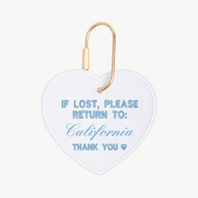 Heart-shaped tag with 'If lost, please return to: California' text on a white background