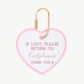 Heart-shaped keychain with 'If lost, please return to: California' text on a white background