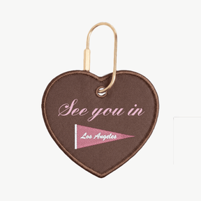 Heart-shaped keychain with 'See you in Los Angeles' text and flag design on a white background
