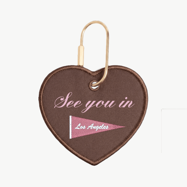 Heart-shaped keychain with 'See you in Los Angeles' text and flag design on a white background