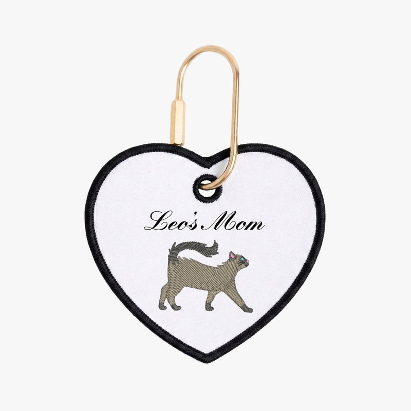 Heart-shaped keychain with a cat illustration and 'Leo's Mom' text on a white background