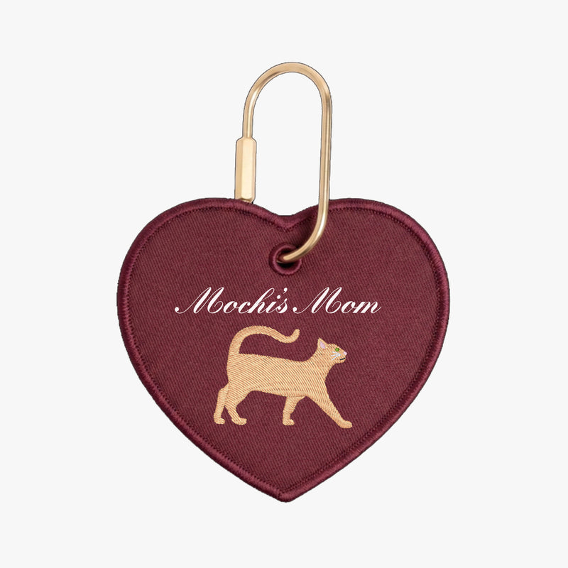 Heart-shaped keychain with 'Mochi's Mom' text and cat silhouette on a white background