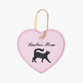 Heart-shaped keychain with 'Simba's Mom' text and black cat silhouette on pink background