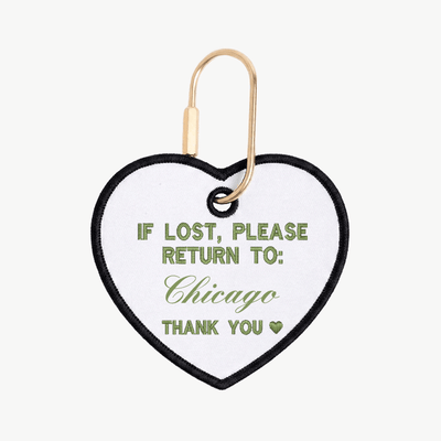 Heart-shaped tag with text 'If lost, please return to: Chicago' on a white background
