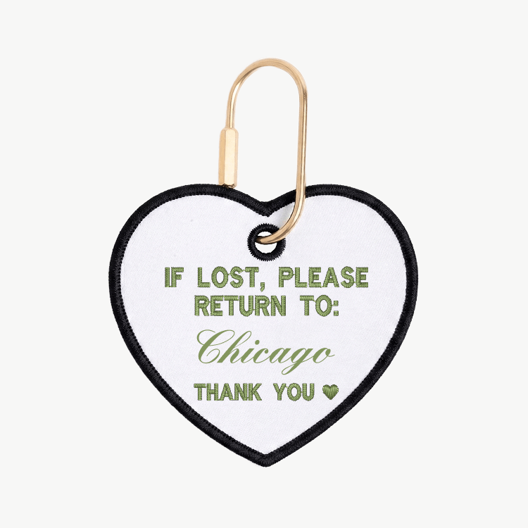 Heart-shaped tag with text 'If lost, please return to: Chicago' on a white background