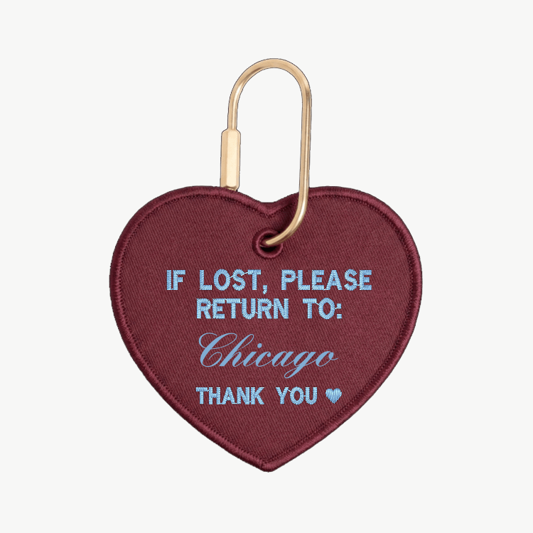 Heart-shaped keychain with text 'If lost, please return to: Chicago' on a white background