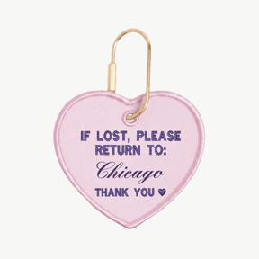 Pink heart-shaped keychain with text 'If lost, please return to: Chicago' on a white background