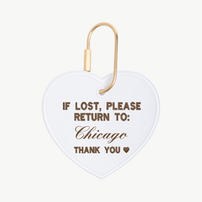 Heart-shaped tag with 'If lost, please return to: Chicago' text on a white background