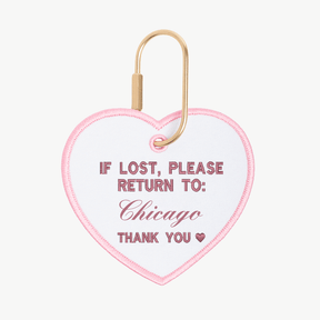 Heart-shaped keychain with text 'If lost, please return to: Chicago' on a white background