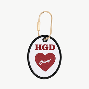 Keychain with red heart and text on a white background