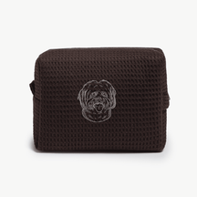 A dark brown waffle zippered pouch with a white line drawing of a dogs face on the front.