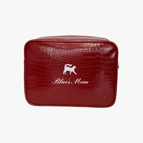 A red croc pouch featuring a gray cat emblem and the words Blue's Mom in white script on the front.
