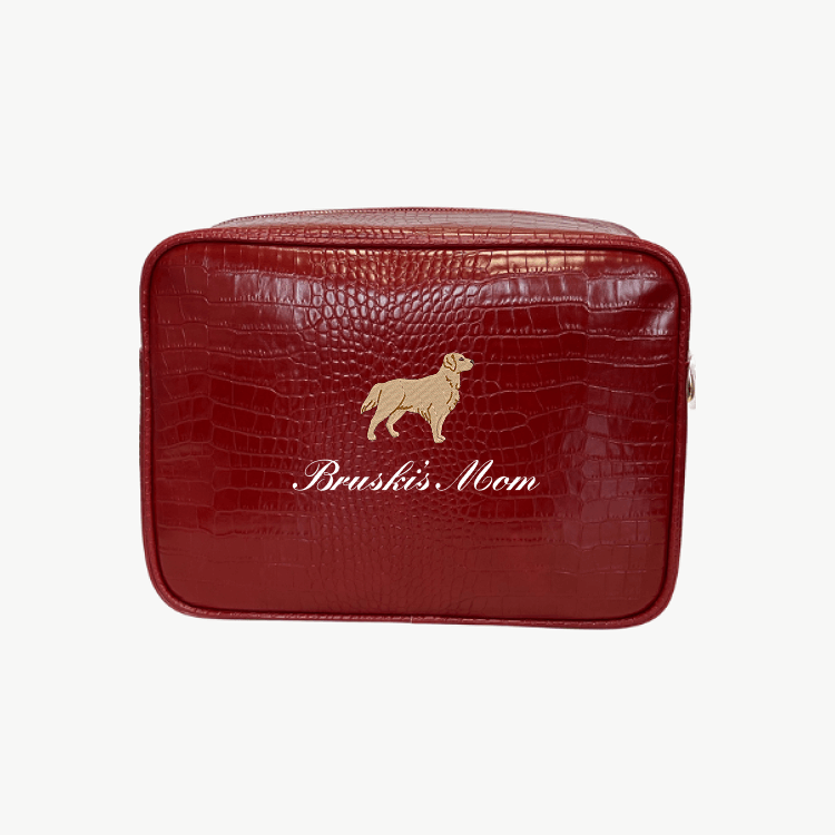 A red croc pouch featuring a large brown dog illustration and the words Bruski's Mom written in cursive on the front.