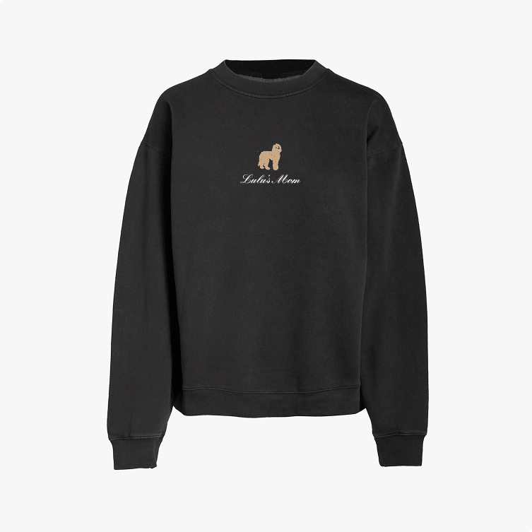 Black crewneck sweatshirt featuring a small embroidered brown dog above the words Lola's Mom in white script on the chest. The sweatshirt has long sleeves and a simple, relaxed design.