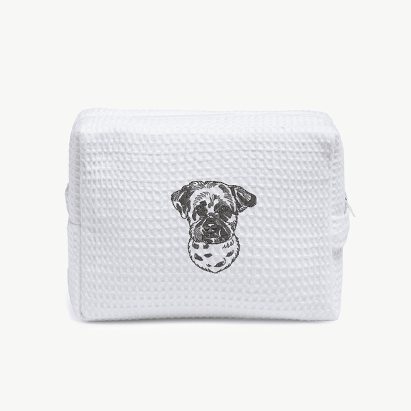 A white waffle zippered pouch with a black line drawing of a dogs face on the front.