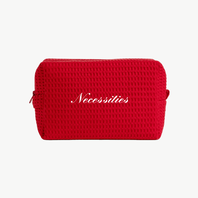 red waffle pouch with embroidered text