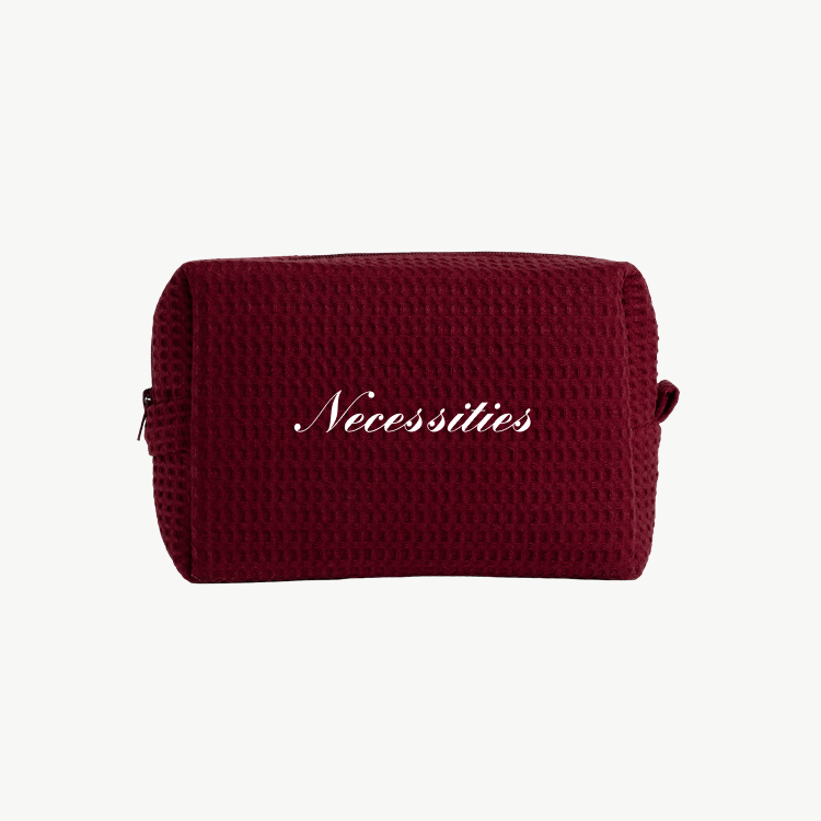 maroon waffle pouch with embroidered text
