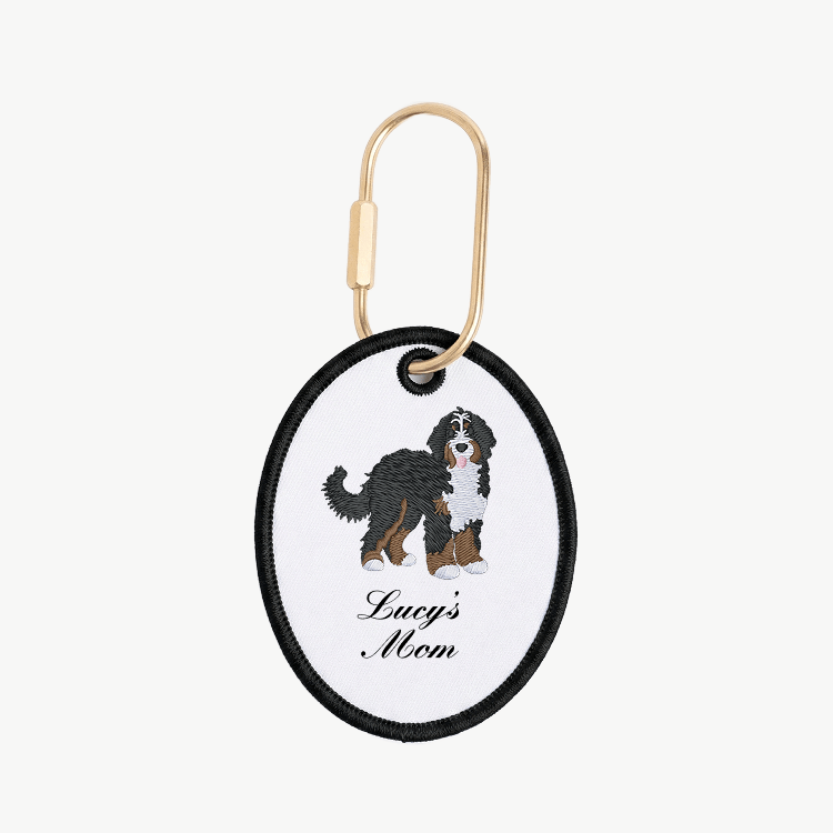 Keychain with Bernese Mountain dog illustration and 'Lucy's Mom' text on a white background