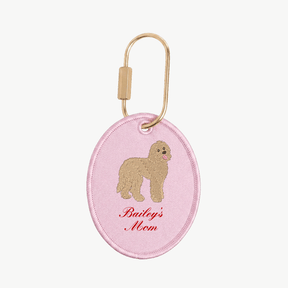 Pink keychain with dog illustration and 'Bailey's Mom' text on a white background