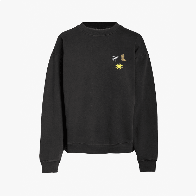 A plain black crewneck sweatshirt with long sleeves featuring three embroidered icons of an airplane, a boots, and a sun, displayed on a white background.