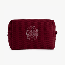 A maroon waffle zippered pouch with a white line drawing of a dogs face on the front.