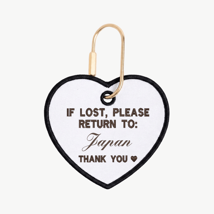 Heart-shaped tag with text 'If lost, please return to: Japan' on a white background