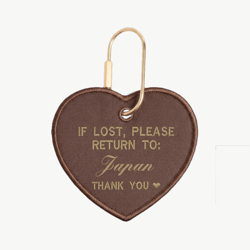Heart-shaped keychain with text 'If lost, please return to Japan thank you' on a white background