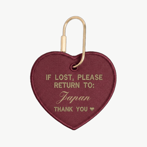 Heart-shaped keychain with text 'If lost, please return to: Japan' on a white background