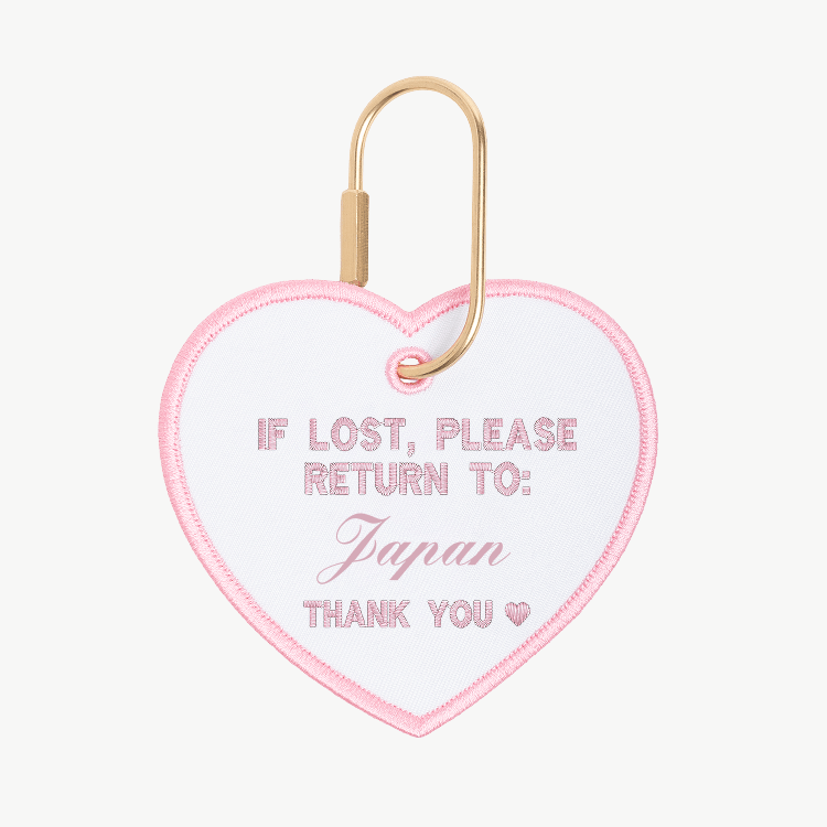 Heart-shaped tag with text 'If lost, please return to: Japan' on a white background