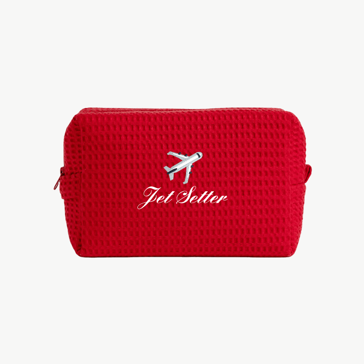 red waffle pouch with embroidered airplane icon and "Jet Setter" text