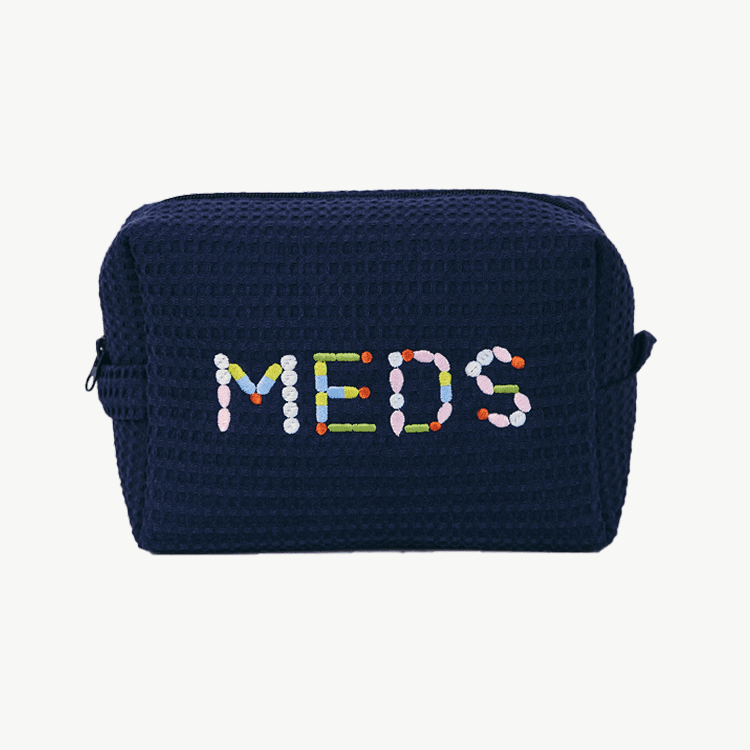 Navy blue pouch with 'MEDS' embroidered in colorful letters on a white background