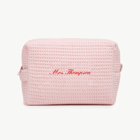 A light pink waffle pouch with the text 'Mrs. Thompson'  on the front, displayed on a plain white background.