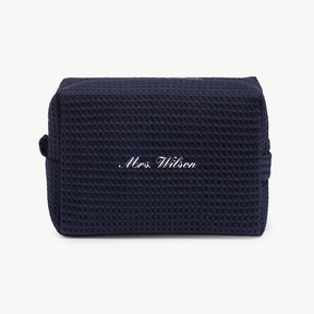 A navy blue waffle pouch with the text 'Mrs. Wilson'  on the front, displayed on a plain white background.