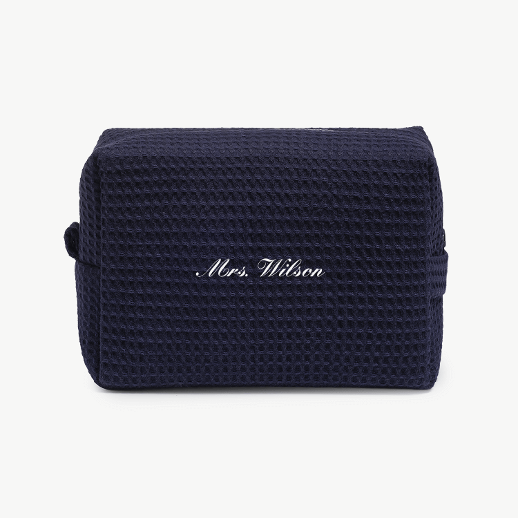 A navy blue waffle pouch with the text 'Mrs. Wilson'  on the front, displayed on a plain white background.