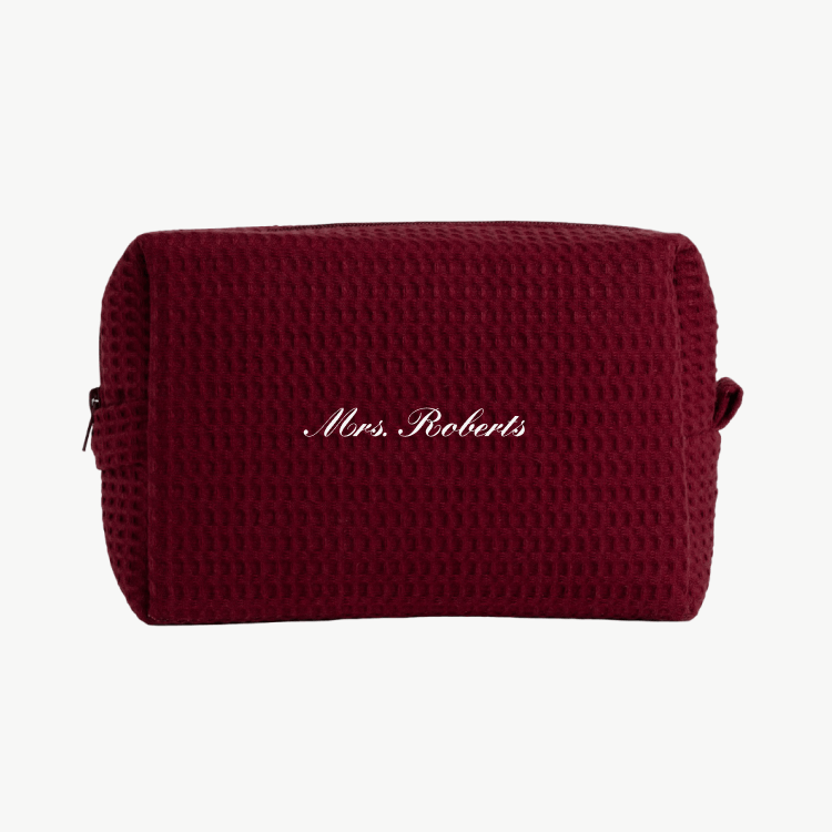 A maroon waffle pouch with the text 'Mrs. Roberts'  on the front, displayed on a plain white background.