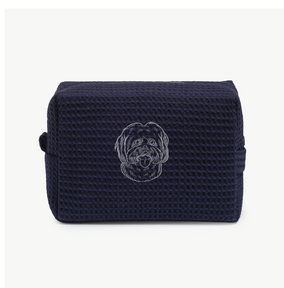 A navy blue waffle zippered pouch with a white line drawing of a dogs face on the front.
