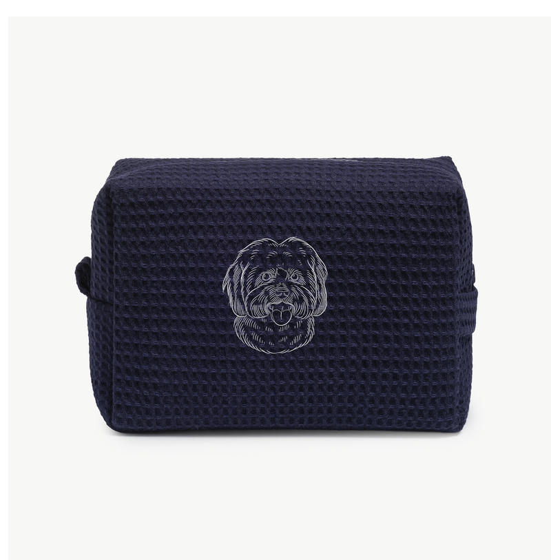 A navy blue waffle zippered pouch with a white line drawing of a dogs face on the front.